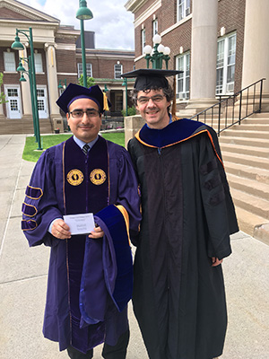UAlbany climate scientist Mathias Vuille takes photo with Ph.D. student Christian Yarleque at his graduation.