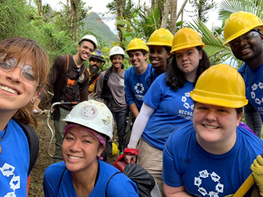 UAlbany student volunteers take a selfie with construction hats on in Puerto Rico.