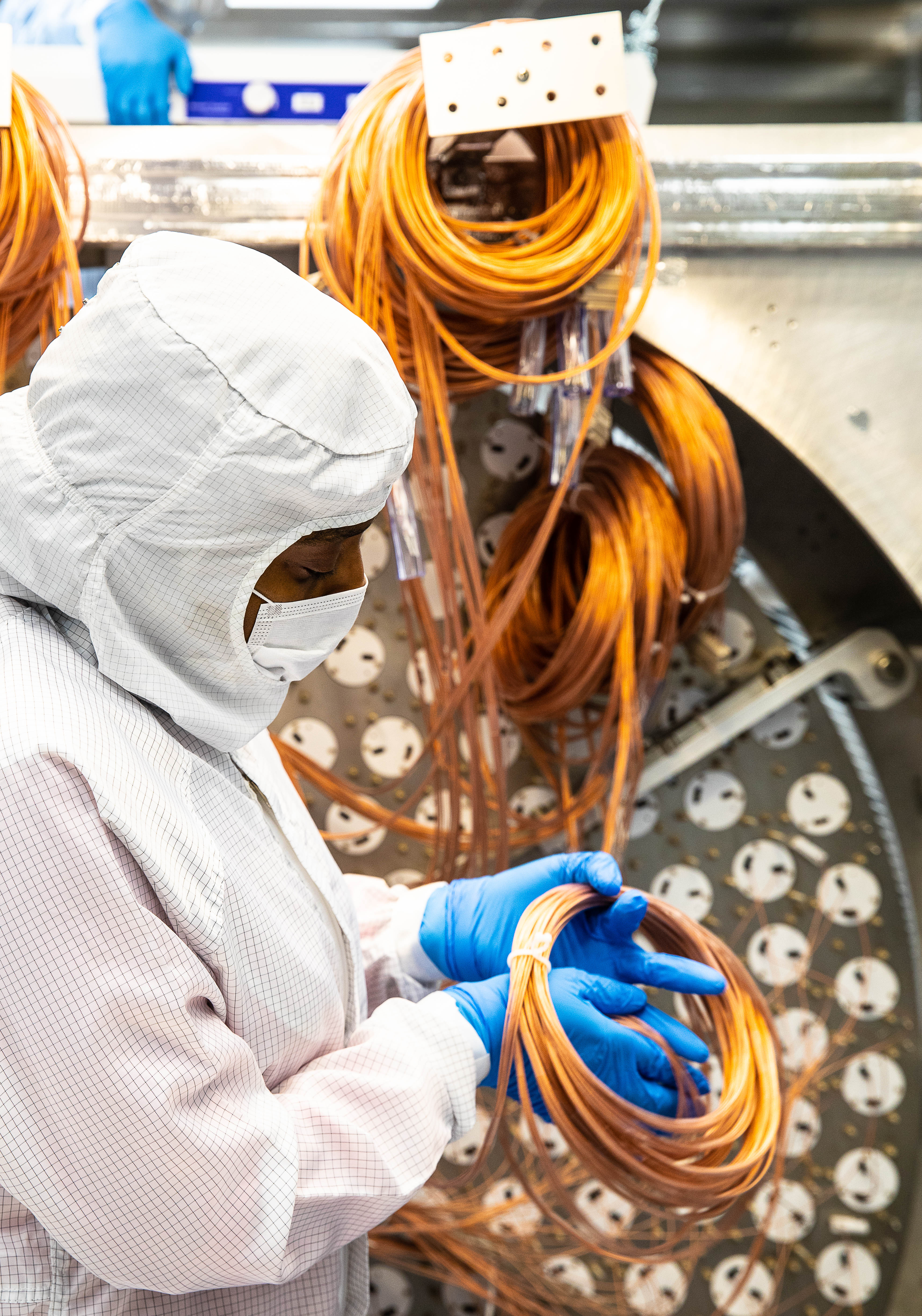 Alvine Kamaha works on the Dark Matter array at SURF