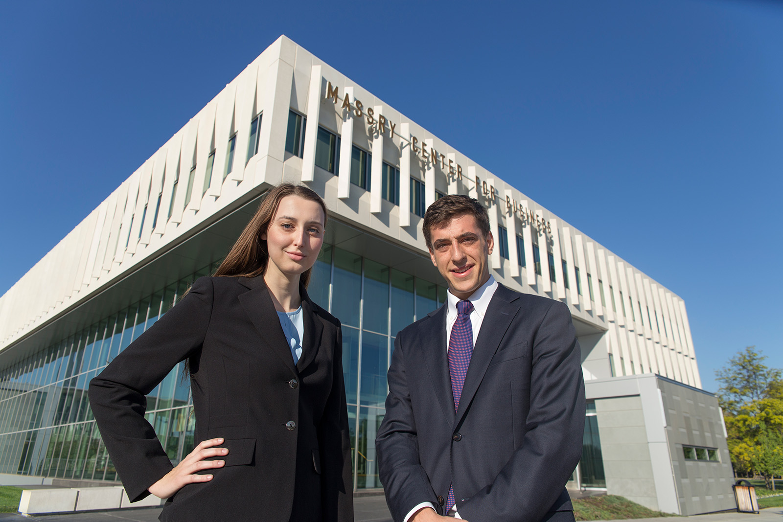 Two students standing in front of the Massry Center for Business