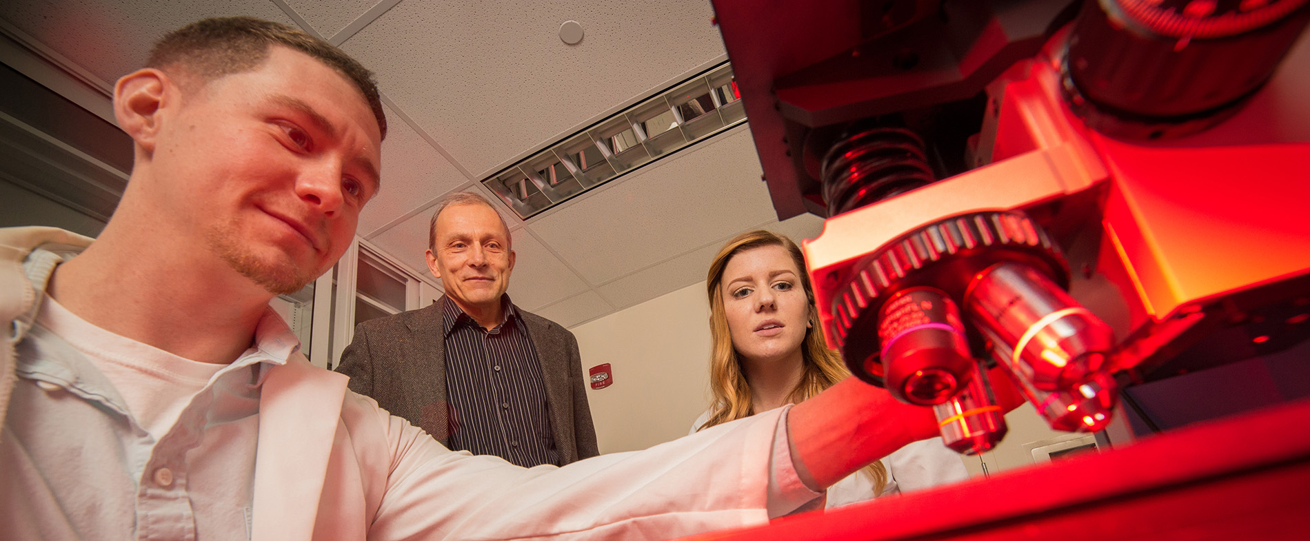 UAlbany Chemistry Professor Igor Lednev works with PhD candidates Claire Muro and Kyle Doty. Photographer: Paul Miller