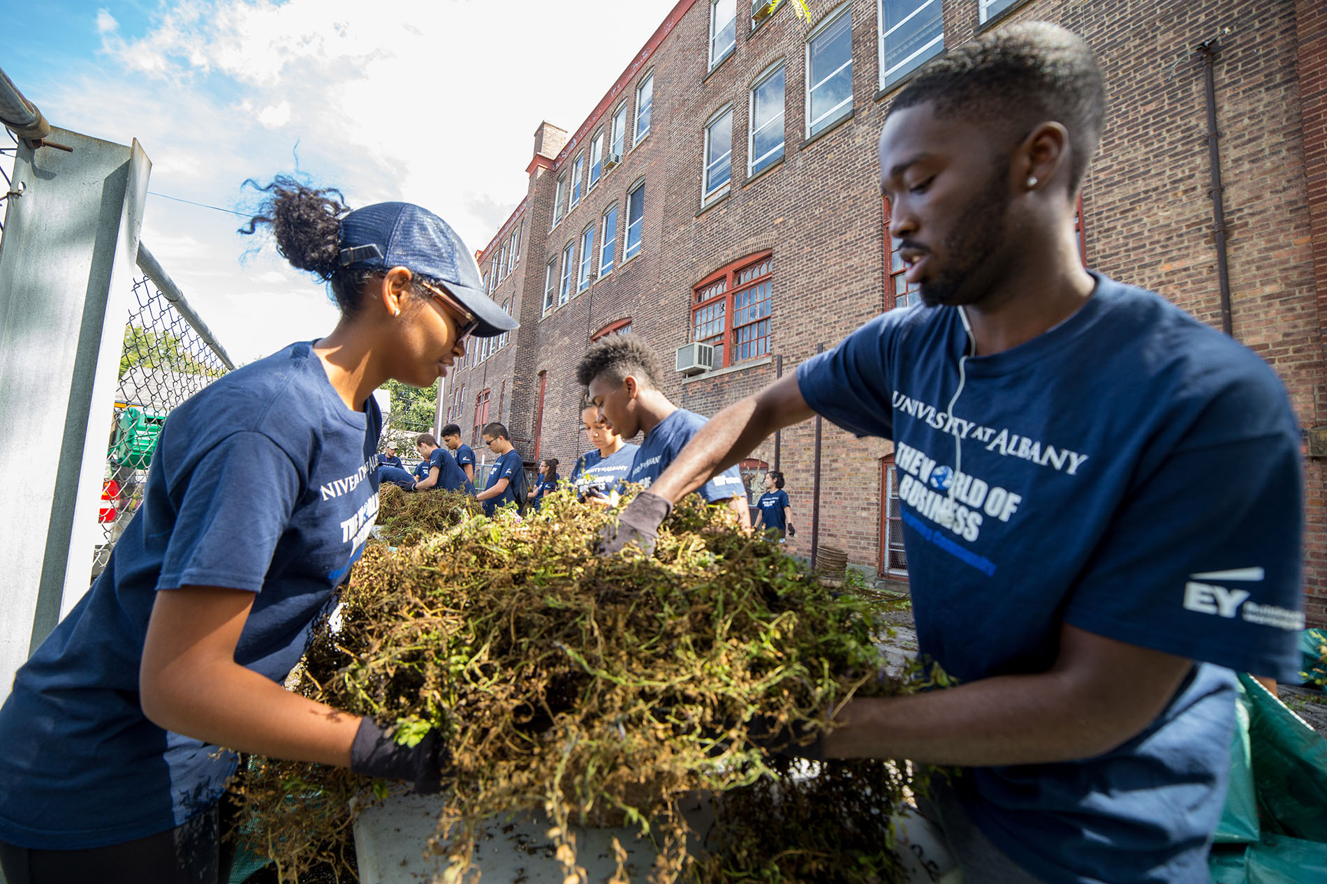 World of business student participate in living-learning community service day with yard-work