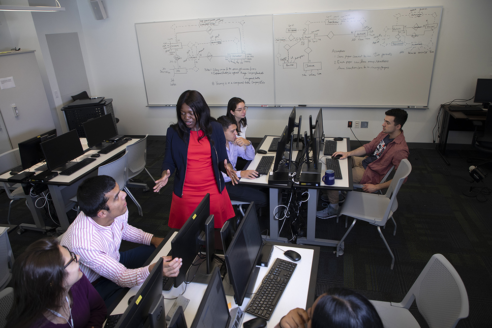 Victoria Kisekka, an assistant professor of information security and digital forensics, trains students in a cyber lab at the School of Business. (Photo by Patrick Dodson)