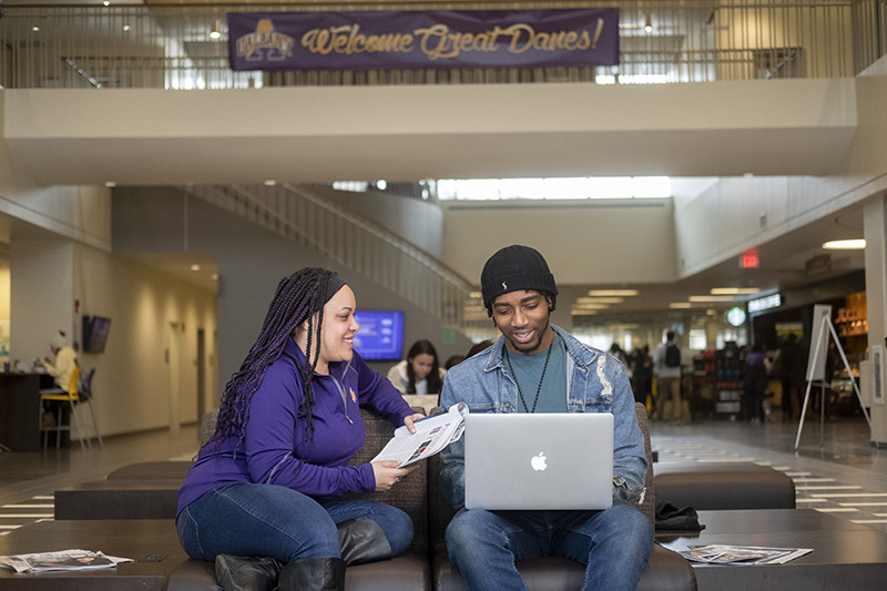 Two students working together in campus center