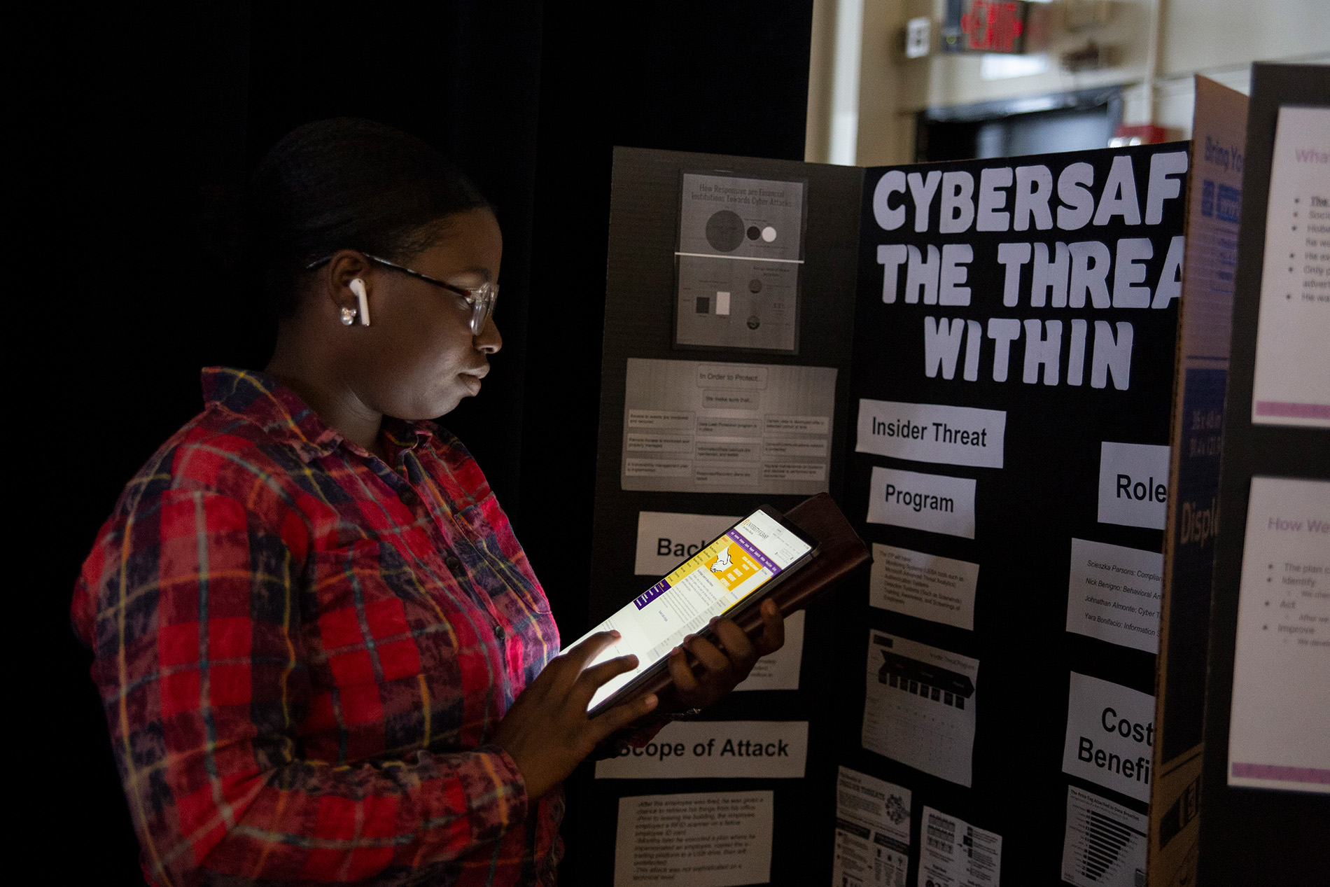 Student reading a poster presentation at the CEHC Showcase event