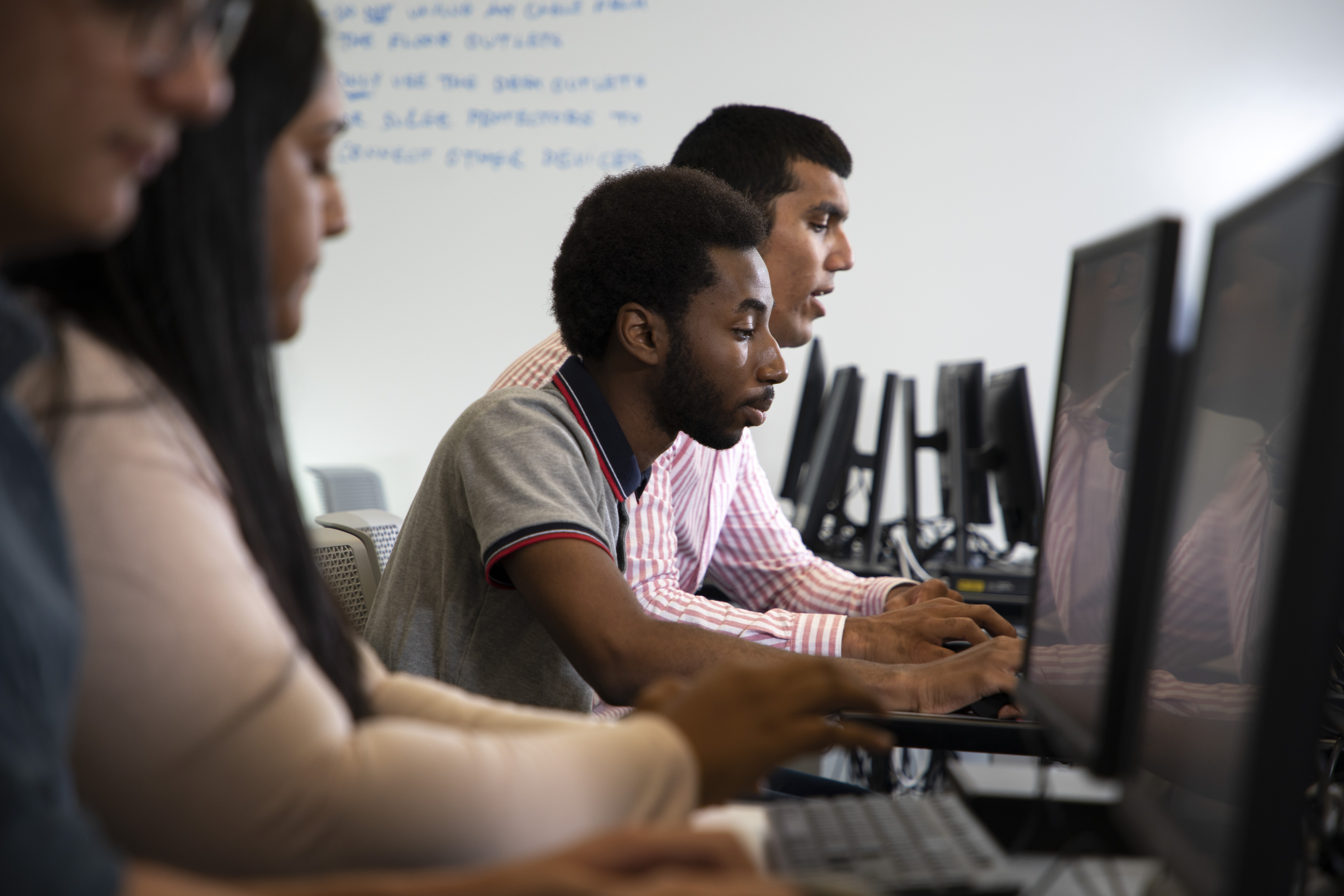 Students work on a project in a computer classroom for digital forensics