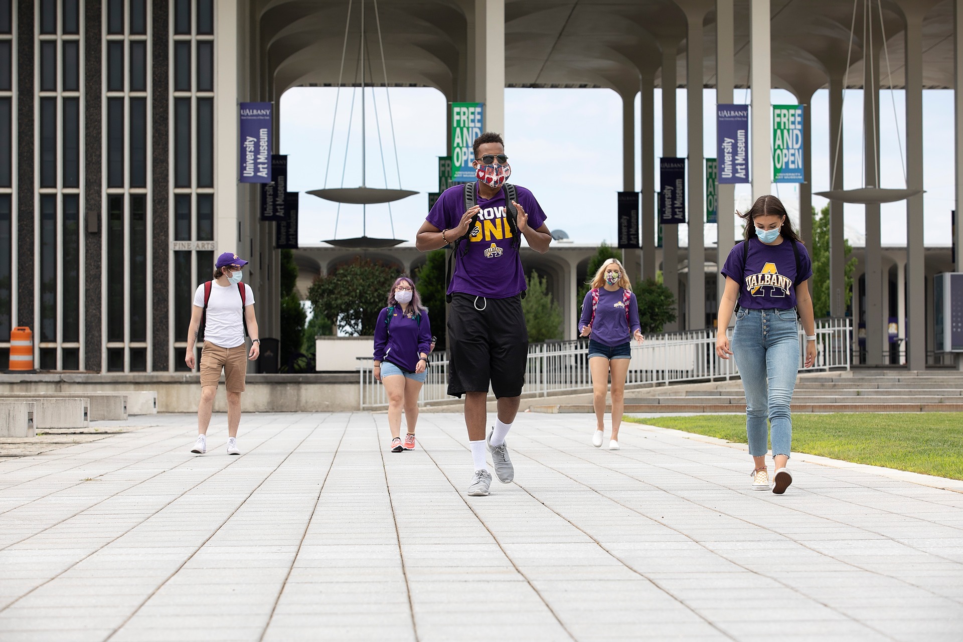 UAlbany students walking on campus wearing masks