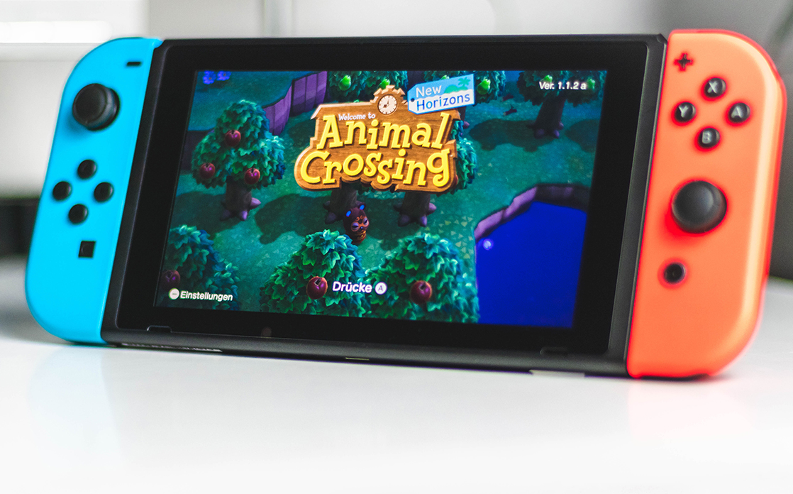 The video game “Animal Crossings: New Horizons," is shown on a colorful widescreen iPhone