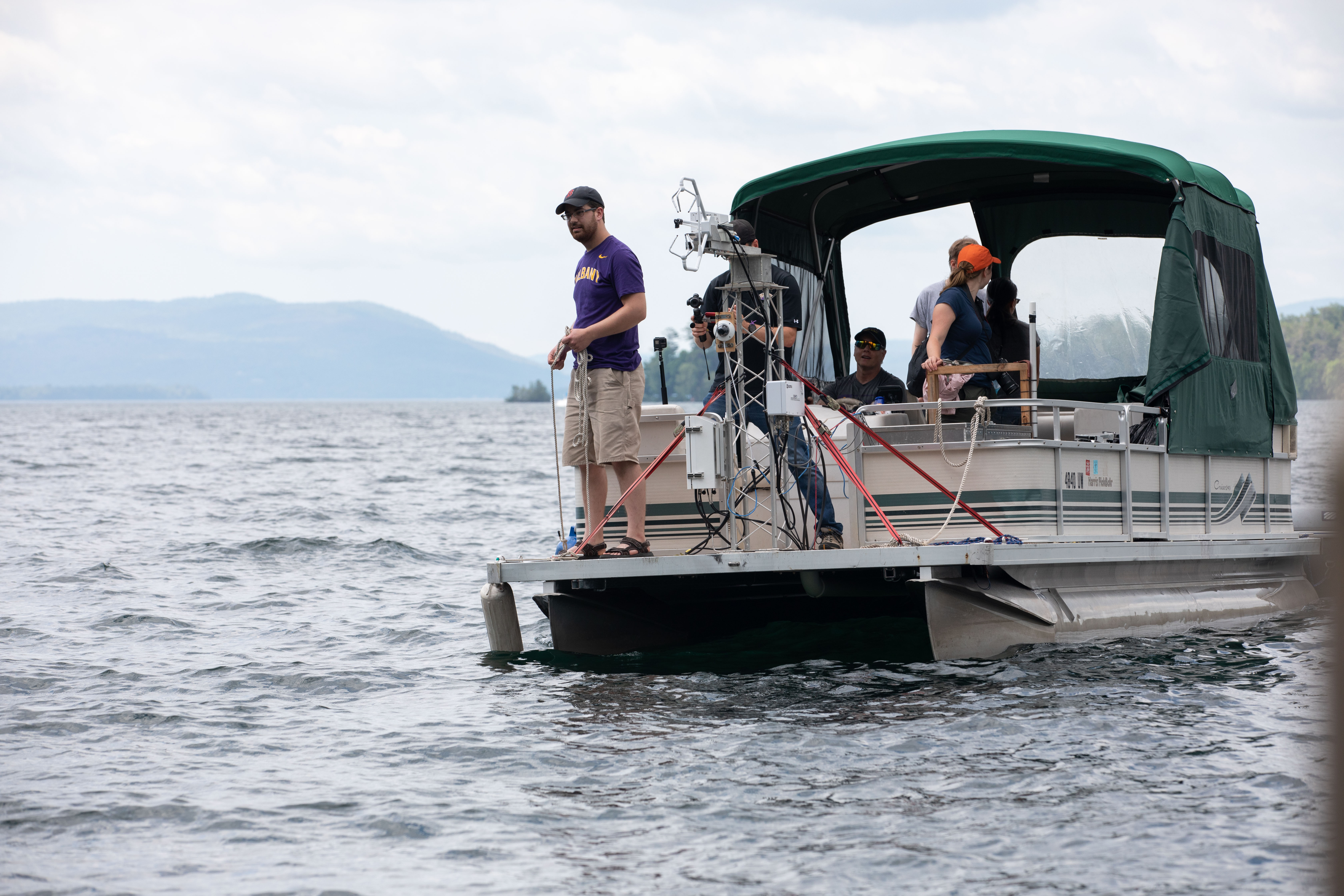 ASRC researchers ride a pontoon boat on Lake George that is used to monitor air-sea interactions close to the surface. 