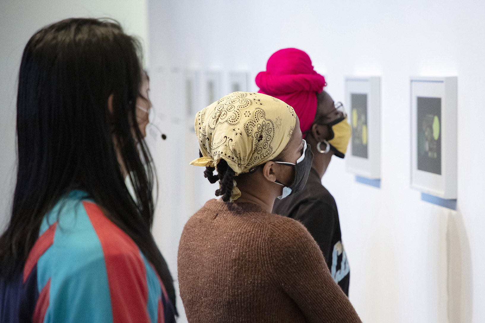 Students looking at framed works on paper