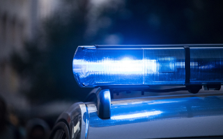 A blue light on a police car is lit up.