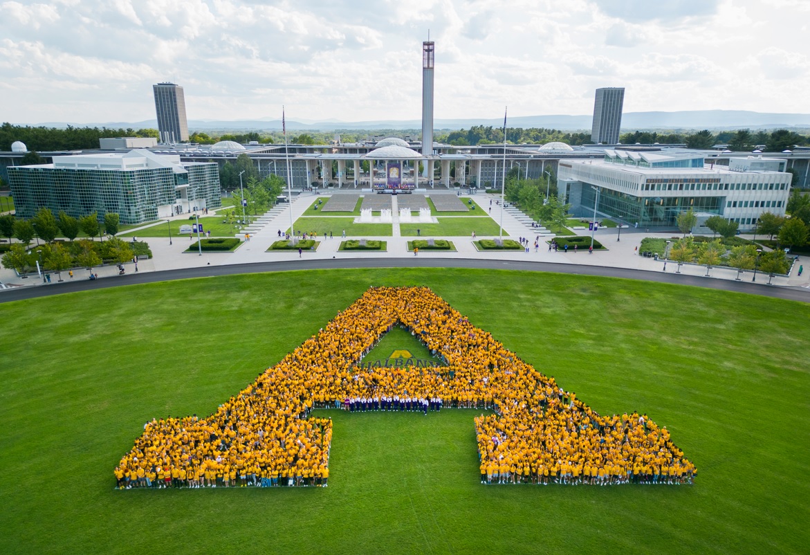 The class of 2026 gathers in yellow shirts in the shape of an "A" on Collins Circle. The photo is taken from a drone.  