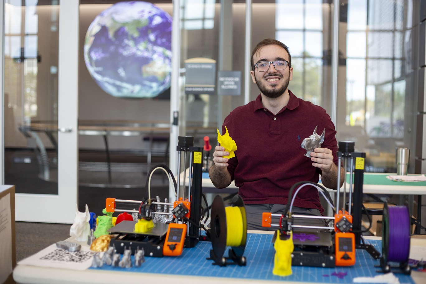 Robert Shepherd displays 3D-printed Damien head statues.