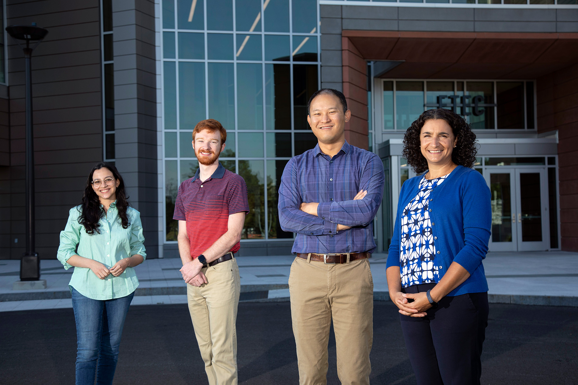 NSF project leaders, including both students, stand in front of the ETEC building.