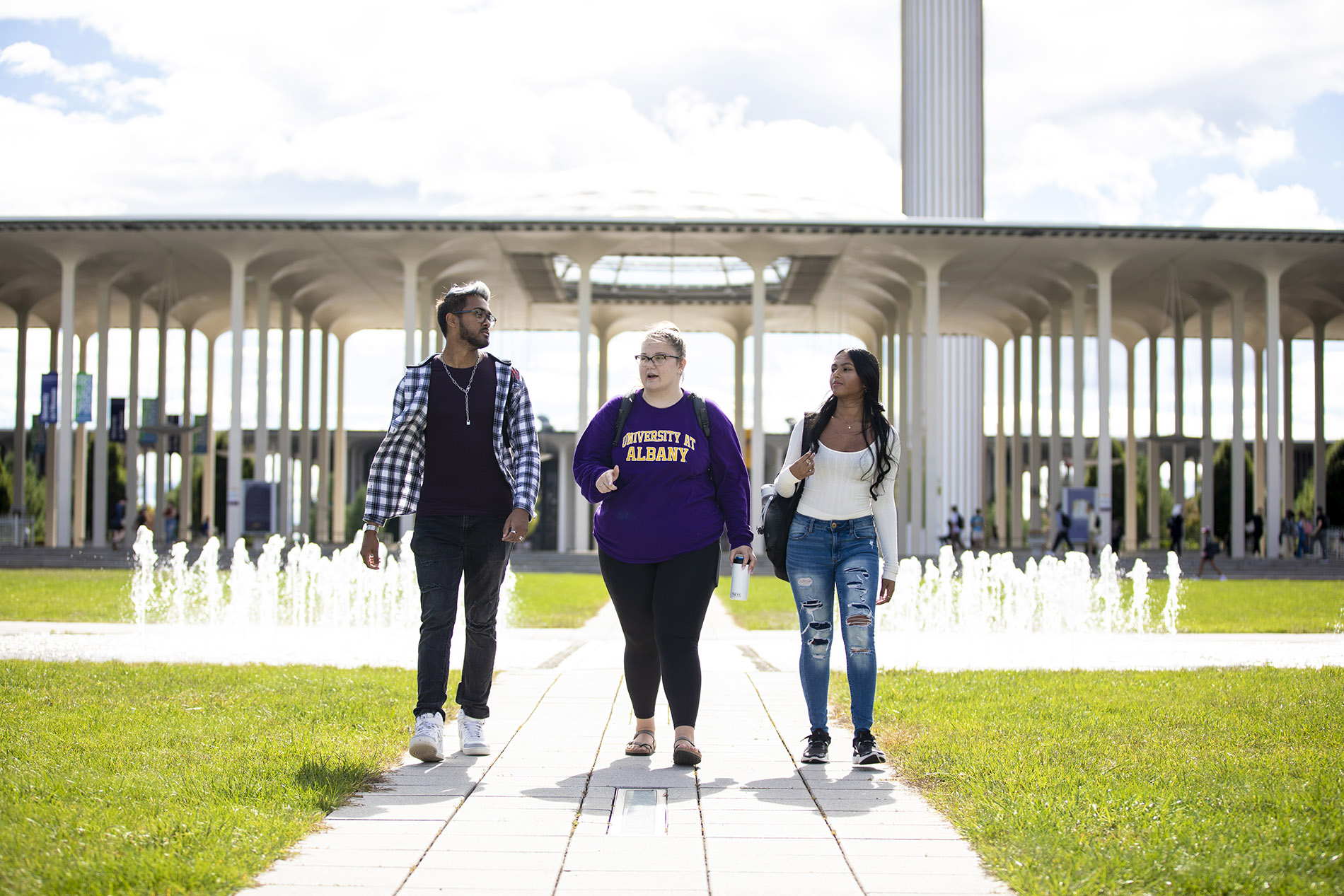 Three students walking together on campus