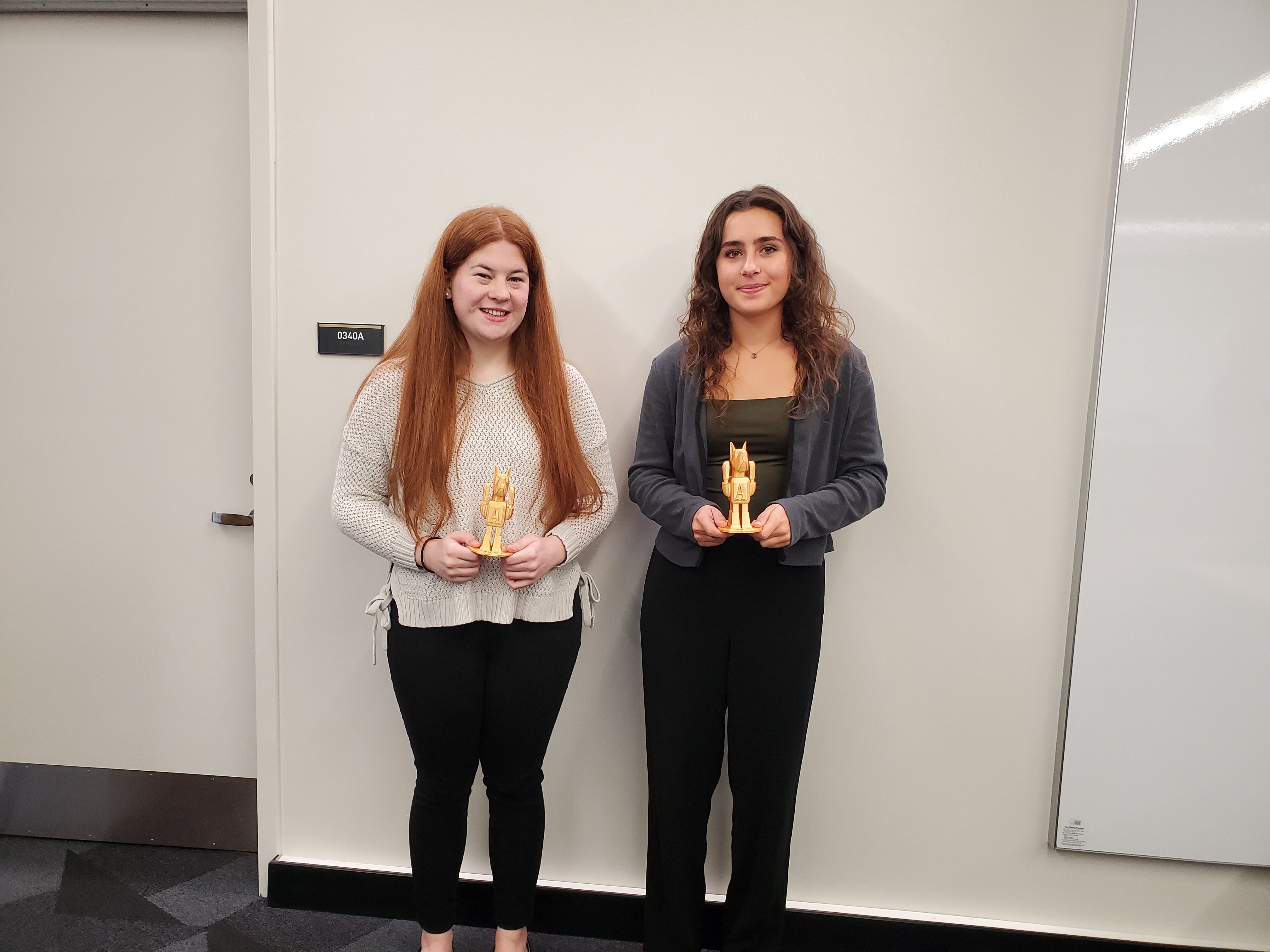 Bailey Vooris and Lauren Liberti proudly display their "Dane Bot" awards.
