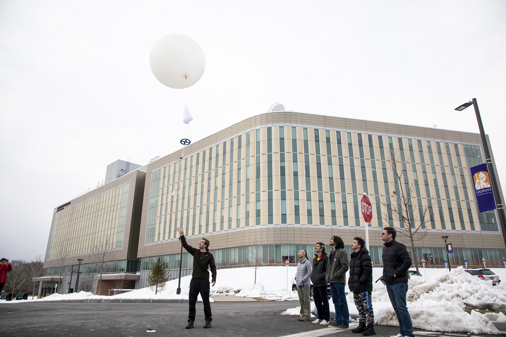 UAlbany student interns launch a weather balloon from the back parking lot of ETEC.