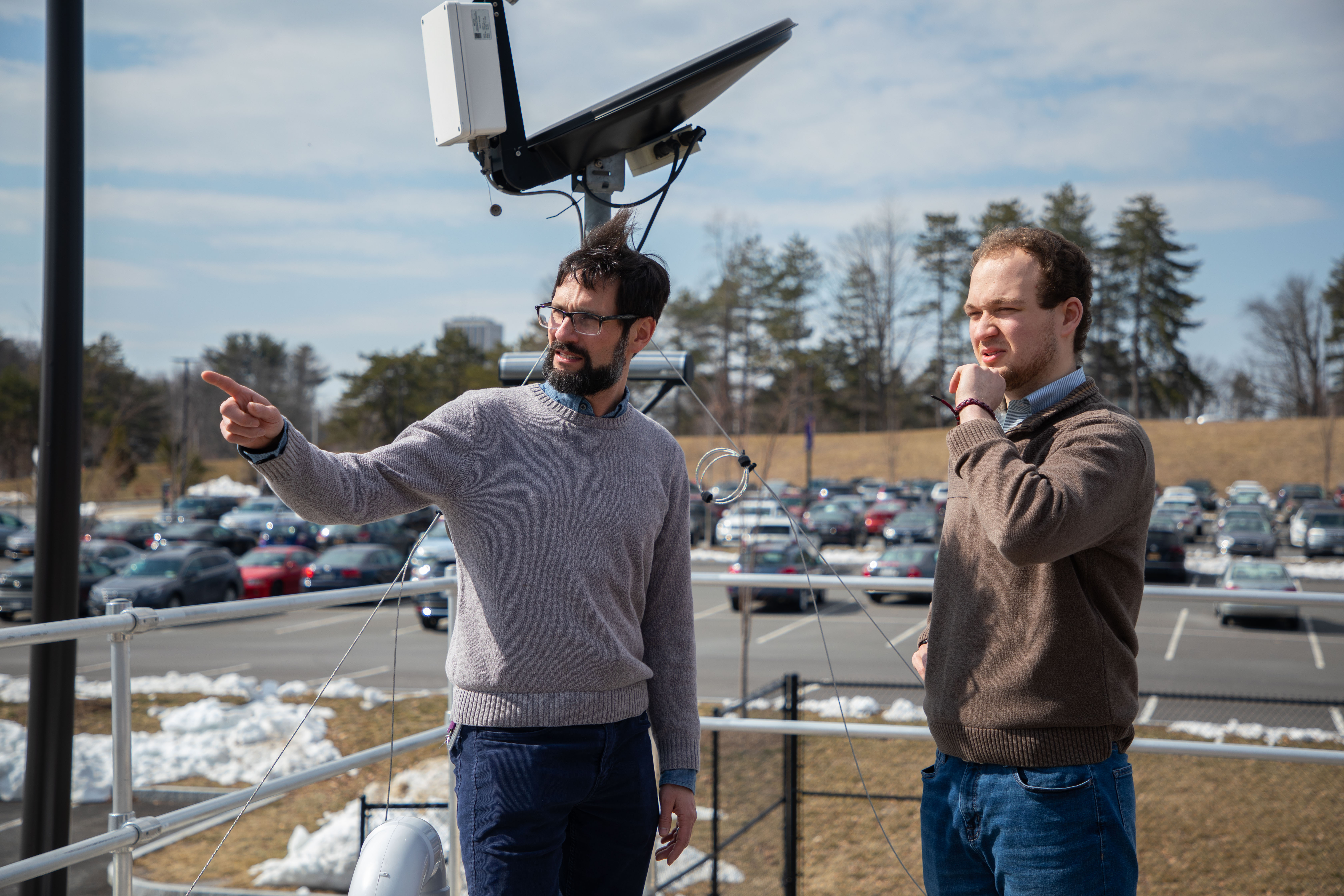 DAES professor Justin Minder and UAlbany senior John England view NYS Mesonet instrumentation outside of ETEC.