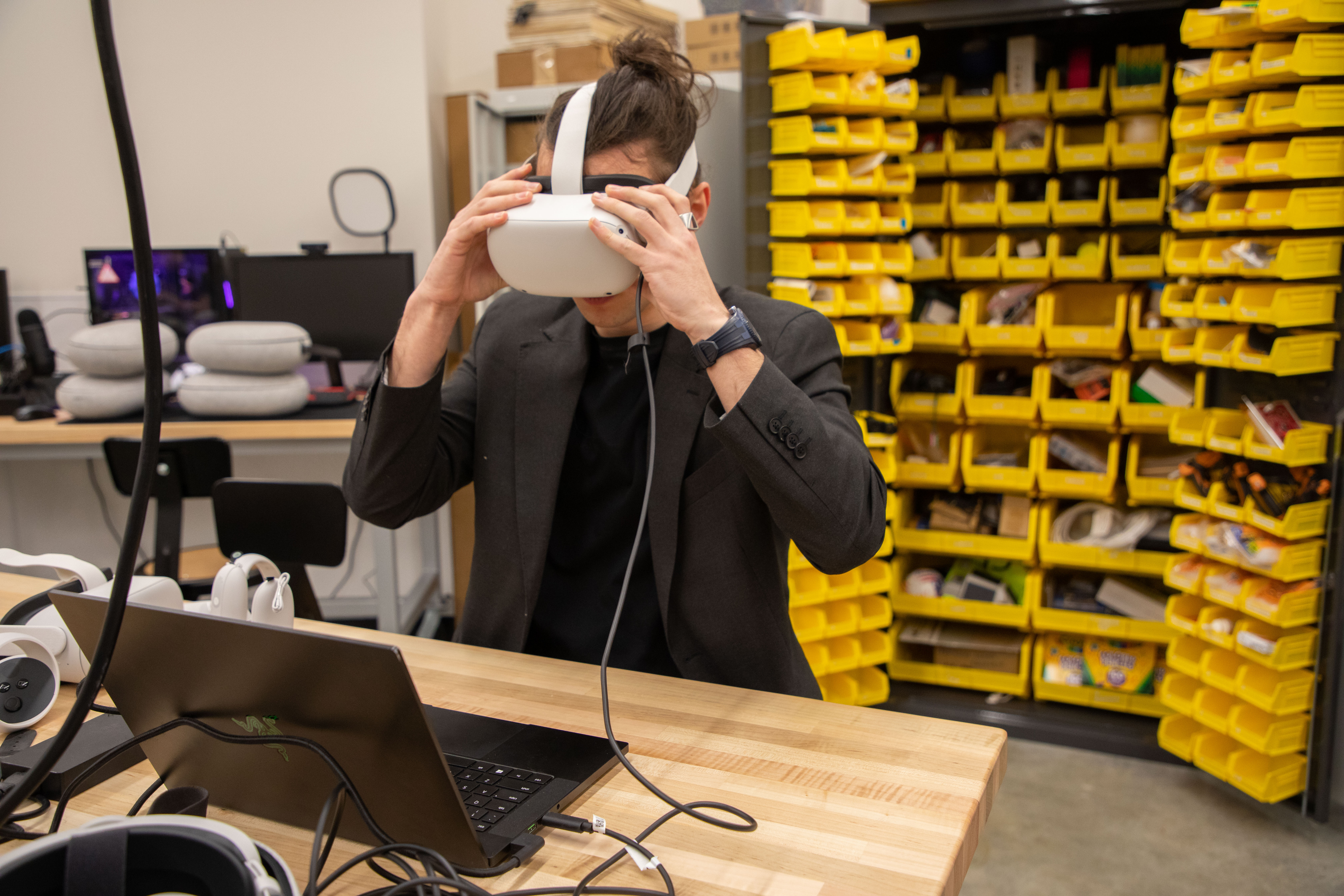 A student at CEHC wears a VR headset in the makerspace at ETEC.