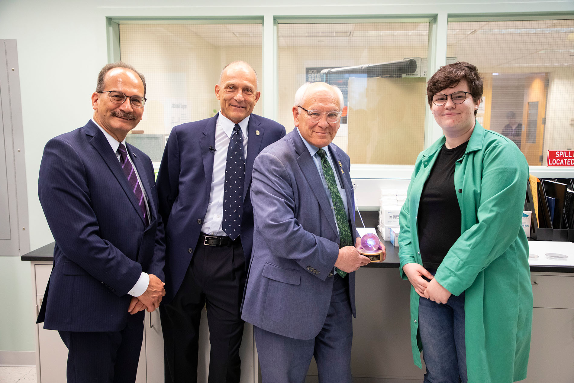 President Rodriguez, Distinguished Professor of Chemistry Igor Lednev, Congressman Tonko and a UAlbany student researcher stand together for a photo inside the Lednev lab. 