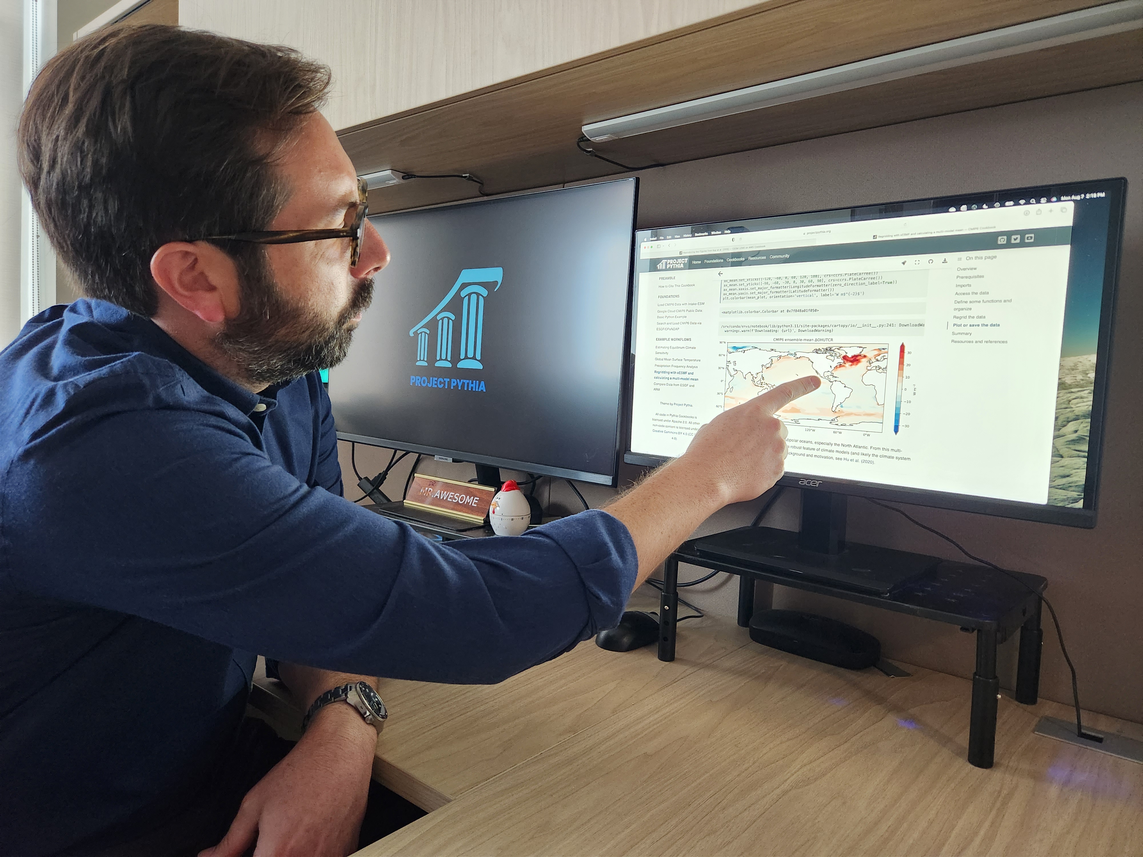 Brian Rose points at a map from a Pythia cookbook on his computer screen.