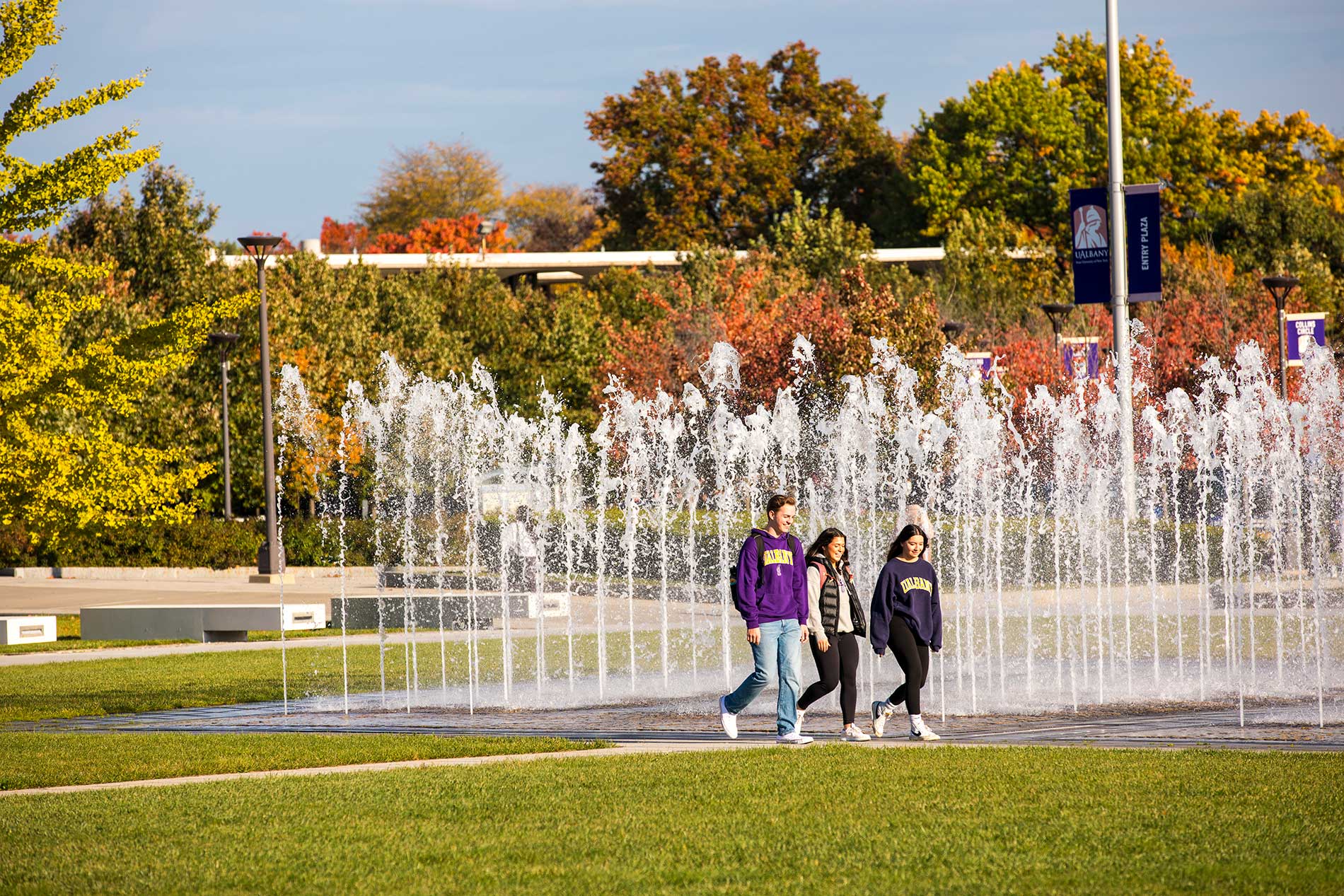 Three students walking together on campus.