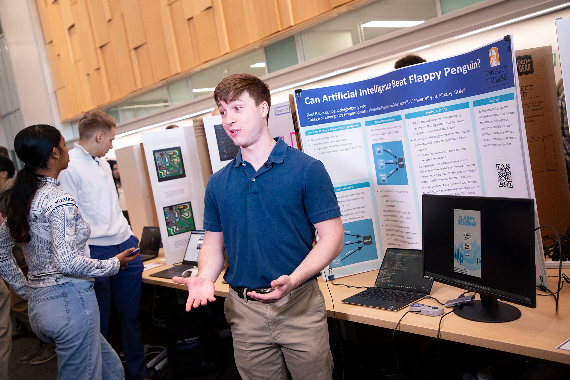 Paul Bauccio stands in front of his "Flappy Bird" project at CEHC's Fall 2023 Showcase.