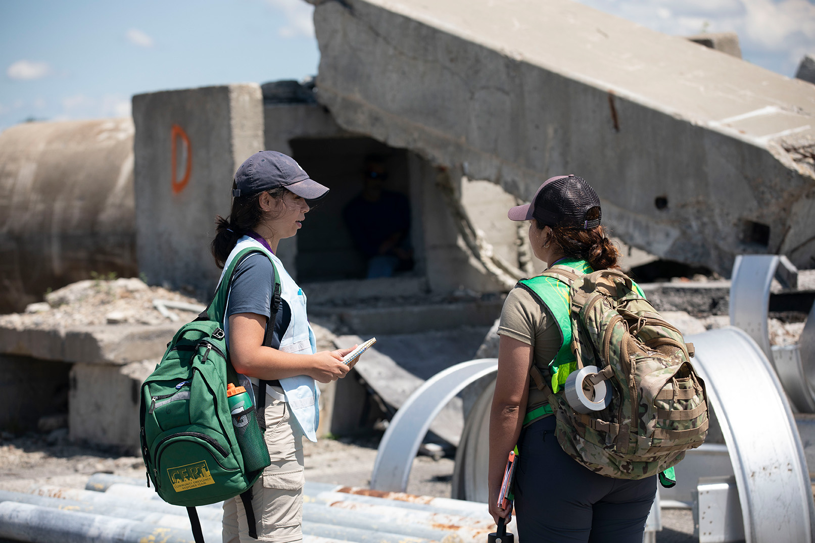Students assess the damage of a collapsed building during a search and rescue simulation at the State Preparedness Training Center. 