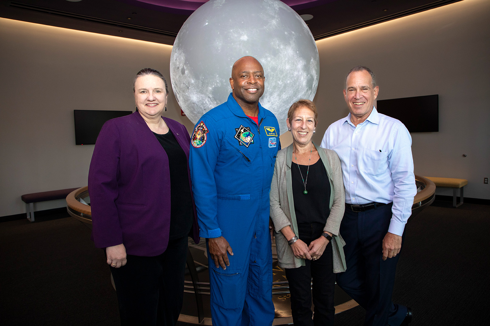 CNSE Dean Michele J. Grimm, Former NASA Astronaut Leland Melvin, Caryn Bunshaft '82, and Albert Bunshaft '80 have their photo taken in the Sphere Room at UAlbany's ETEC.