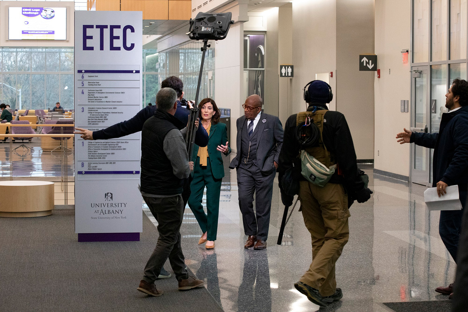 Gov. Hochul and Al Roker walk through the ETEC atrium with the TODAY Show production crew.