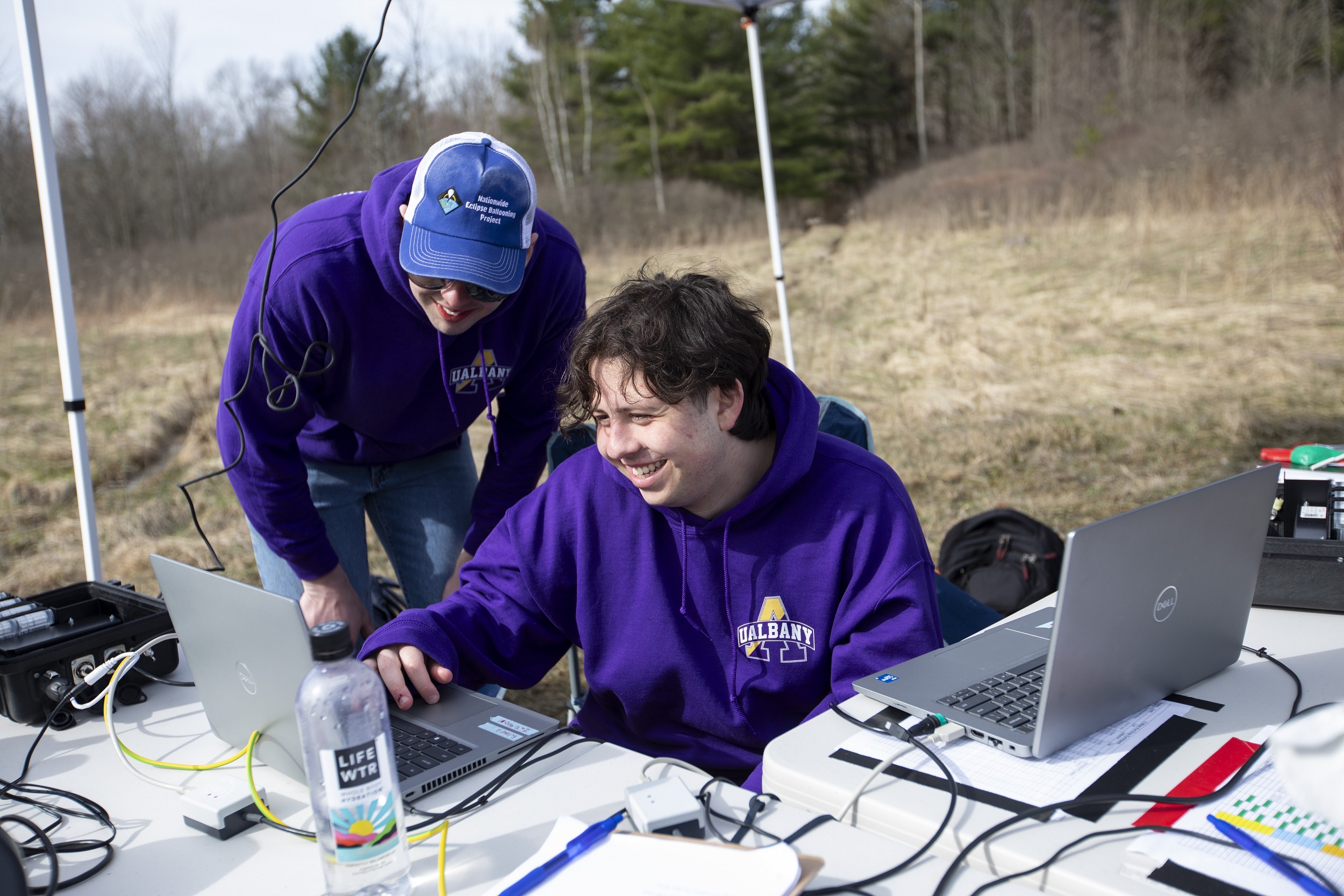 UAlbany seniors David Zywiczynski (left) and Alan Birnbaum review data on laptops at Fort Drum.