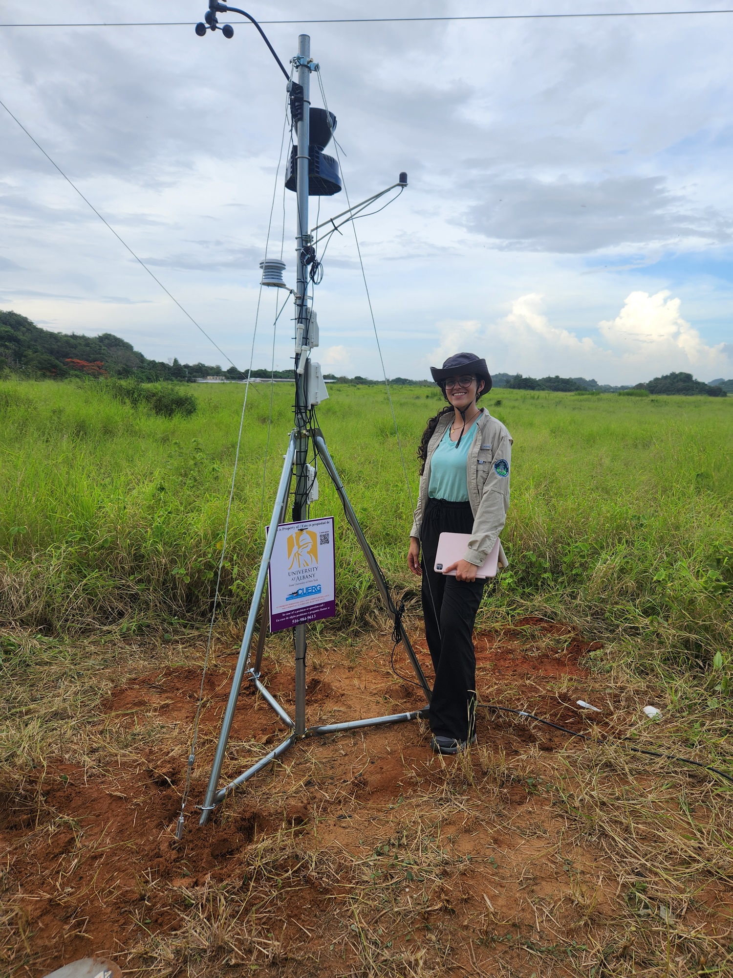 Bianca Méndez Cruz stands next to a sensor used to monitor Puerto Rico's power grid.