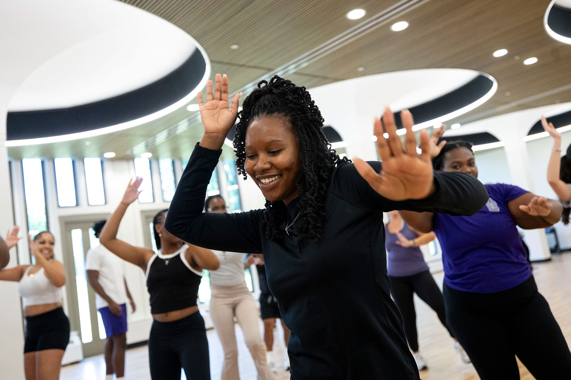 Students dancing together in a class at the Well.