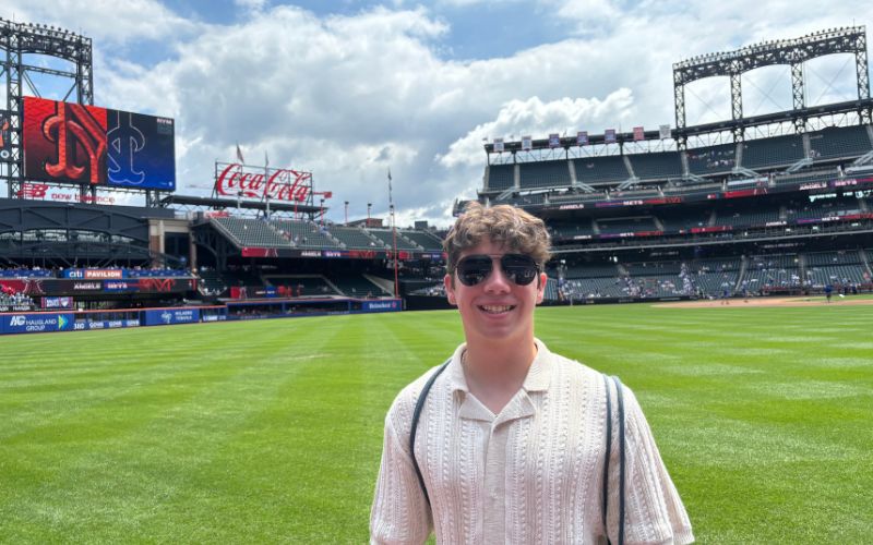 CEHC student Roberto Friedlander stands on the Citi Field Stadium baseball field. 