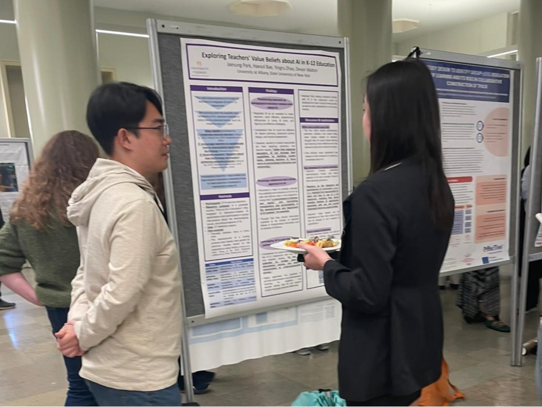 individuals looking at a research poster