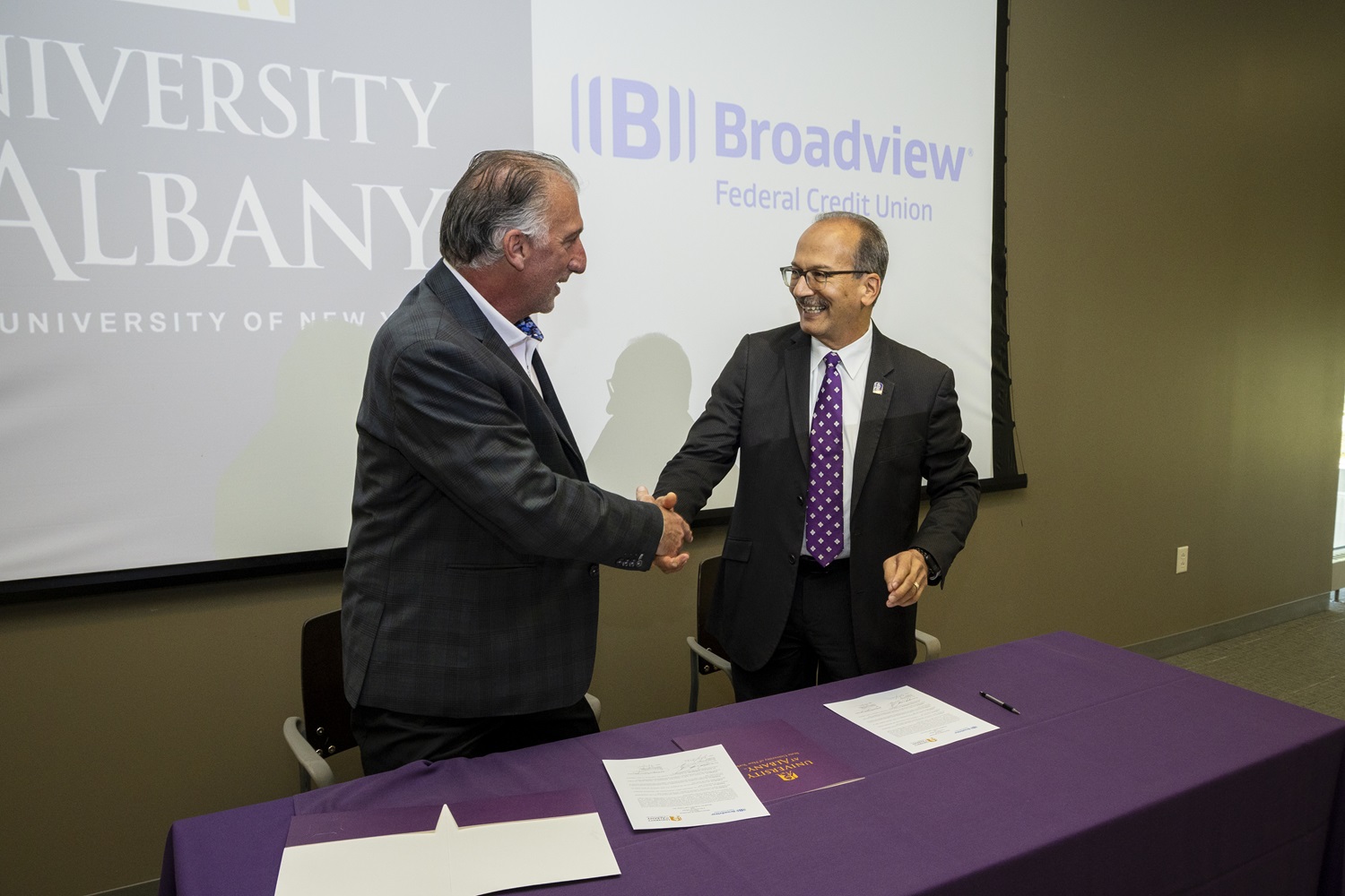 UAlbany President and Broadview CEO shake hands following signing agreement 