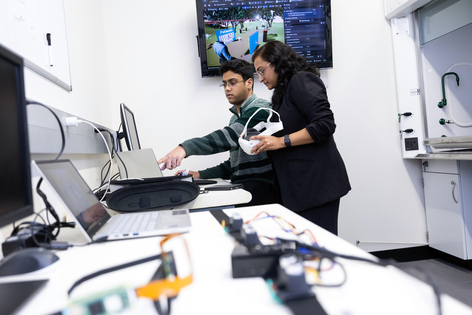 Jeremy Varghese and Aishwari Talhan conduct research in the Immersion Lab.