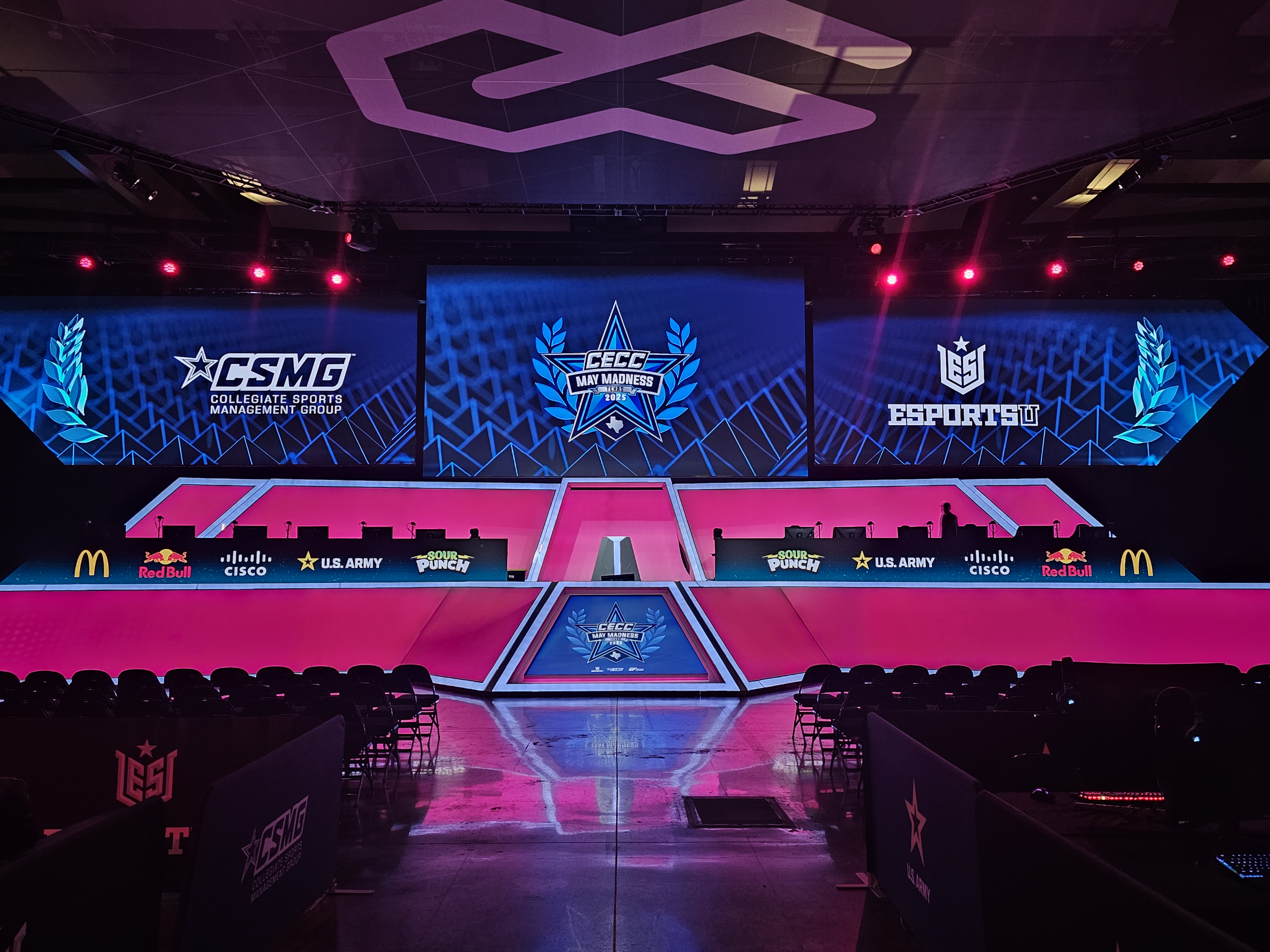 The main stage at the Esports Stadium Arlington lit up in pink and blue lights.