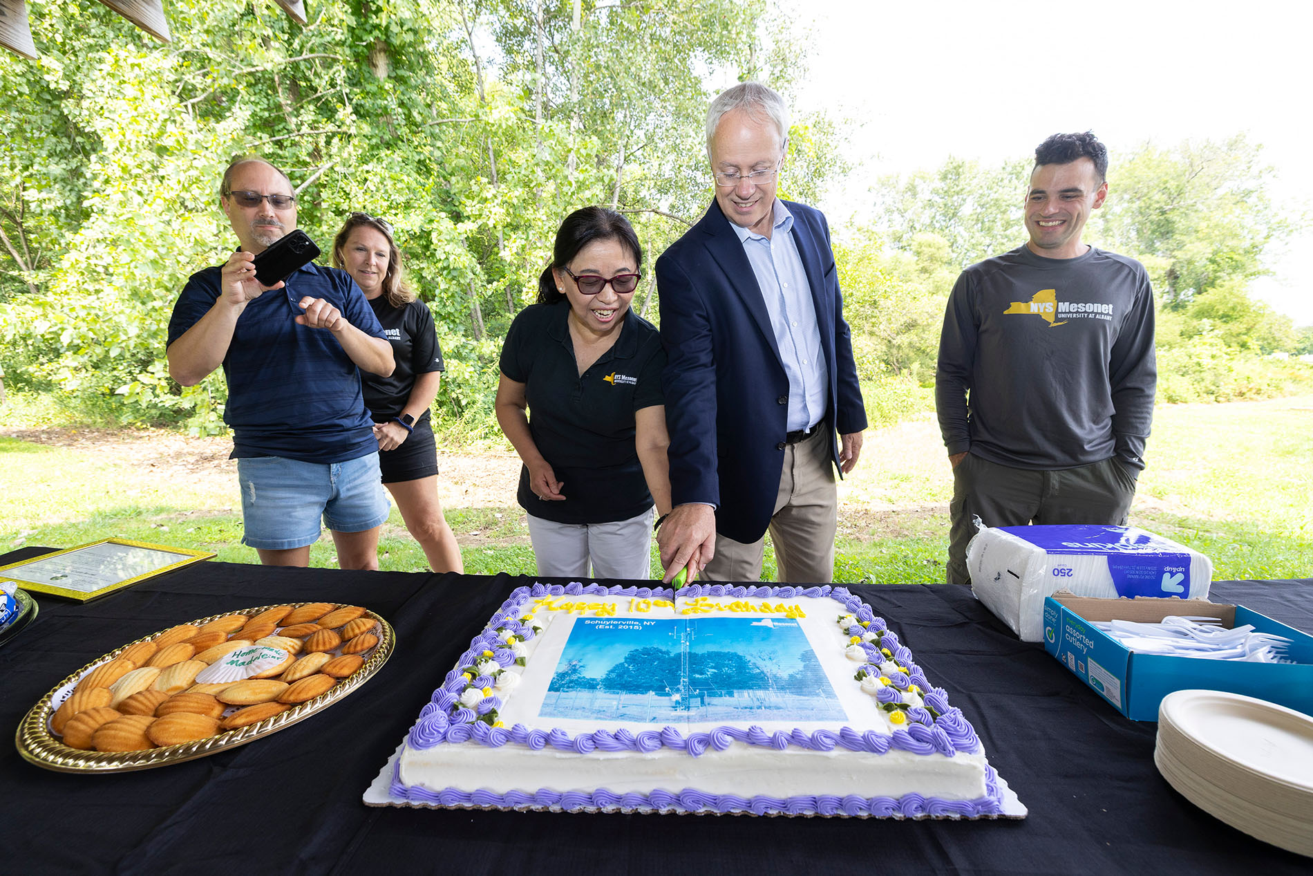 Mesonet leaders cut a cake to celebrate the Schuylerville site's 10th birthday.