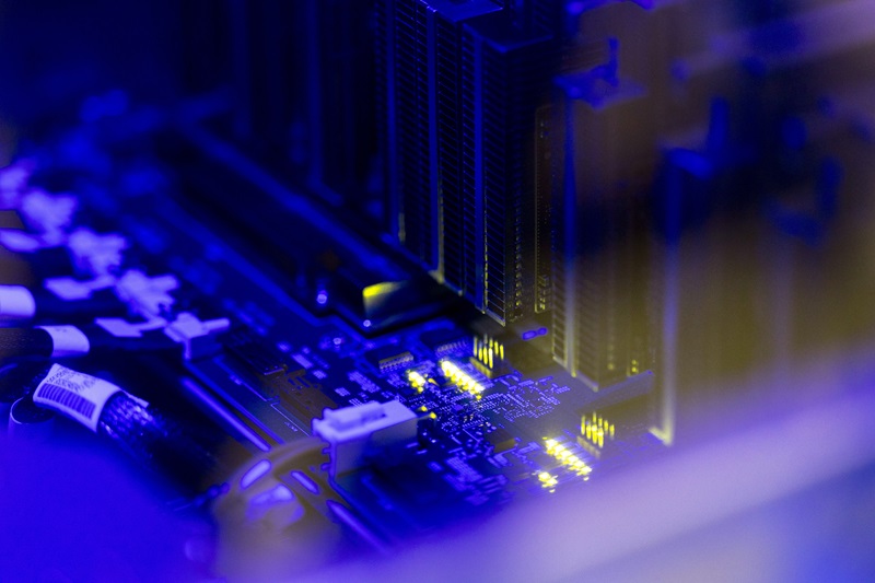 A close up of the circuitry and components inside a computer server rack.
