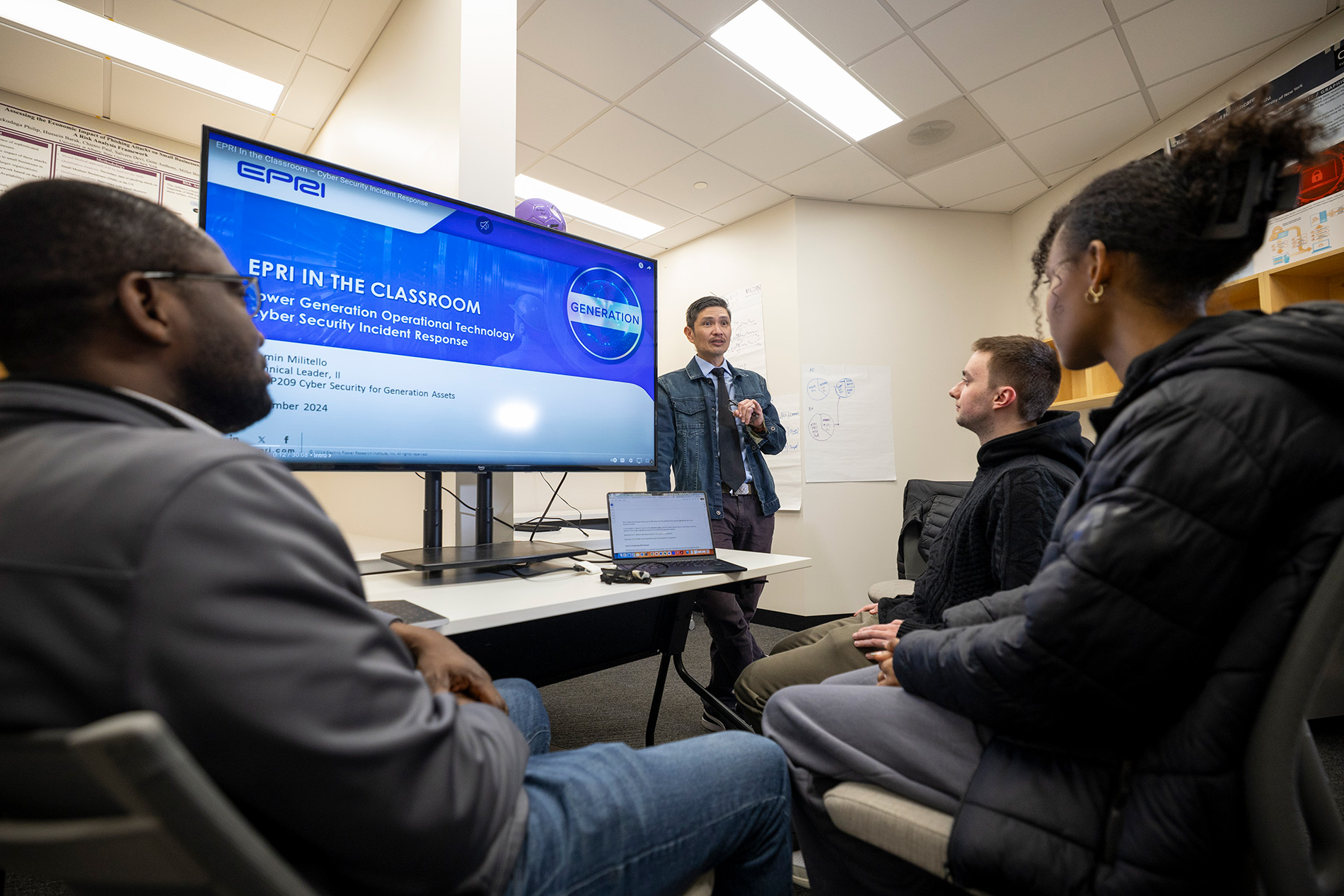 CEHC's Ariel Pinto instructs students from inside the Cyber Cascade Risk lab.