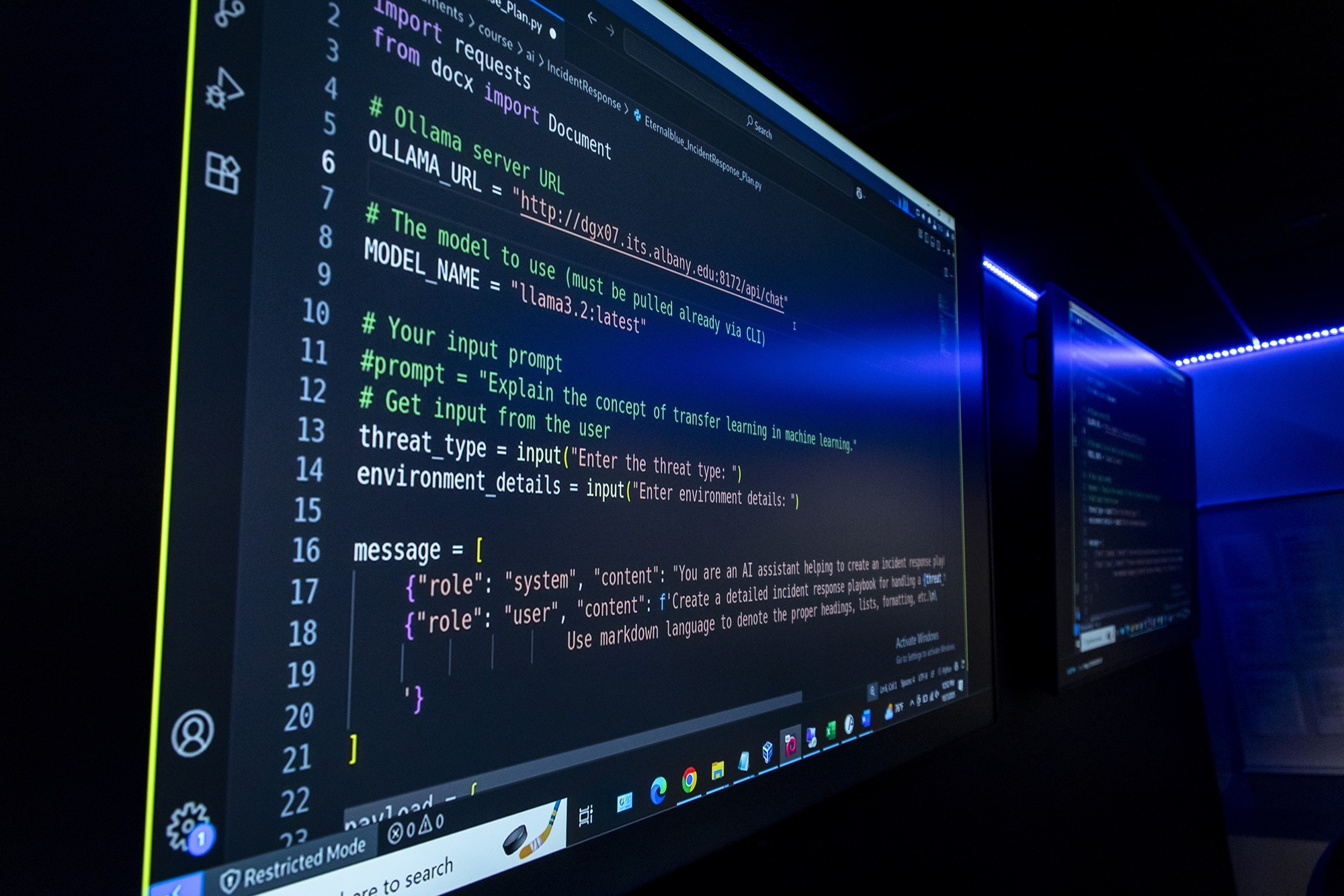 Programming language is displayed on a computer screen in the Cyber Range lab.