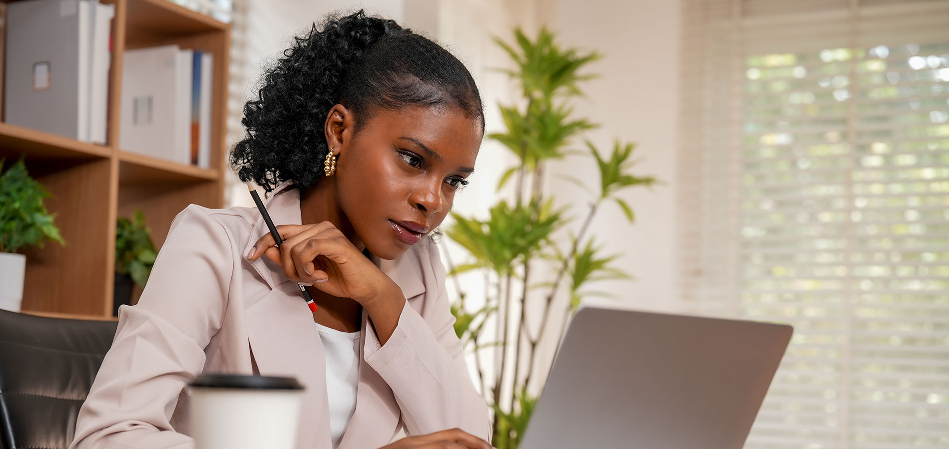 A sociologist reviews research on her laptop.