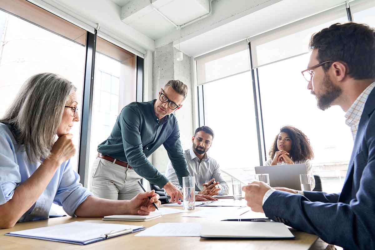 A digital marketing team meets around a conference table.