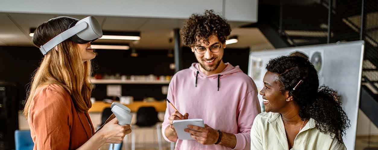 A video game project manager works with a team in testing a new game.