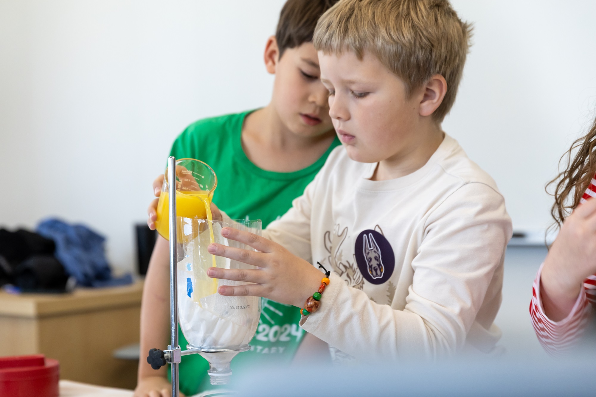 A child conducts a science experiment at ETEC during STEM and Earth Sciences Family Day.