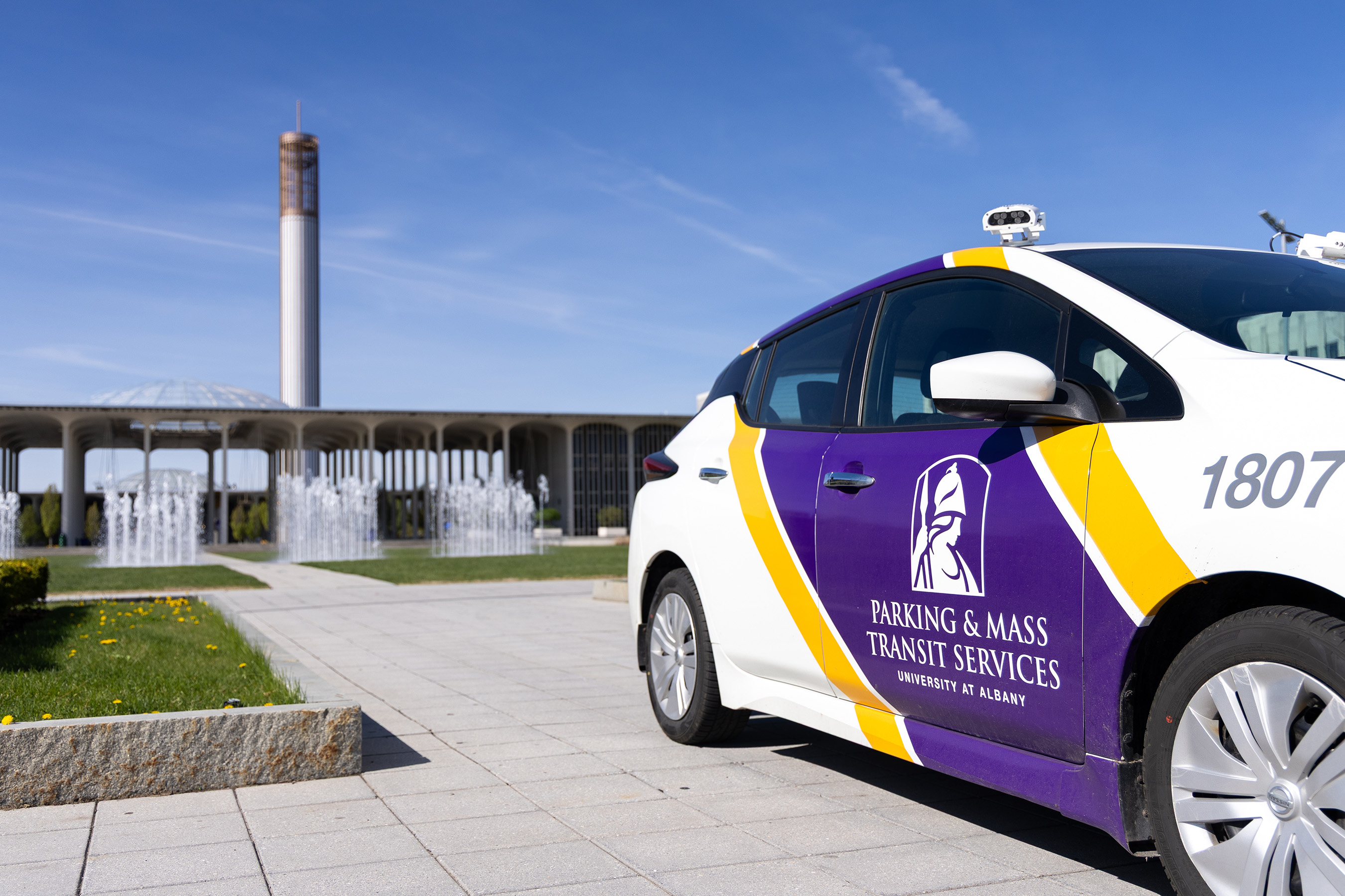 An electric parking facilitaion vehicle sits parked in front of Campus Center.
