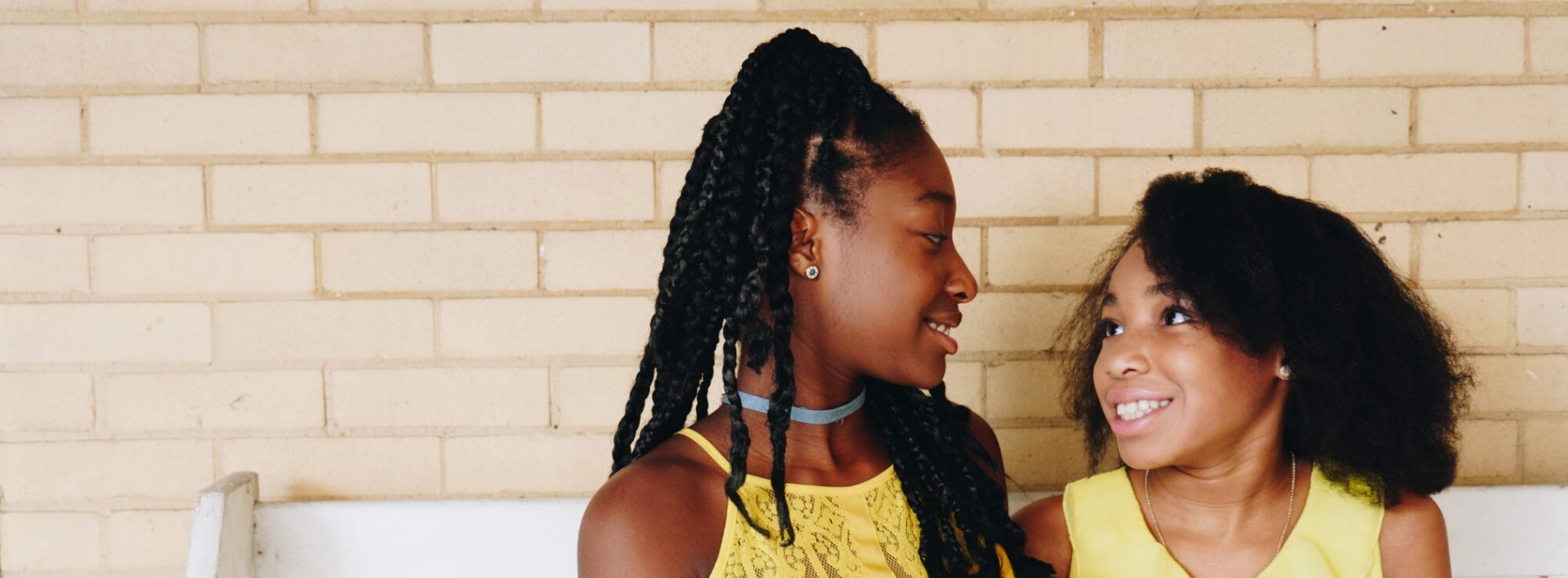 Two students smiling at each other