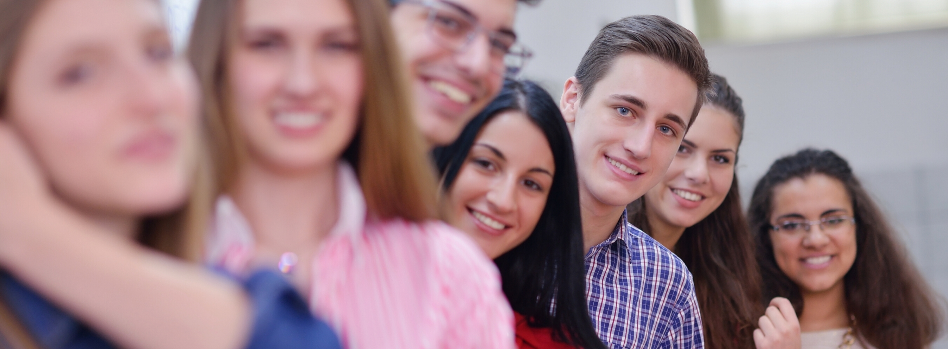 A group of students standing in a line and smiling