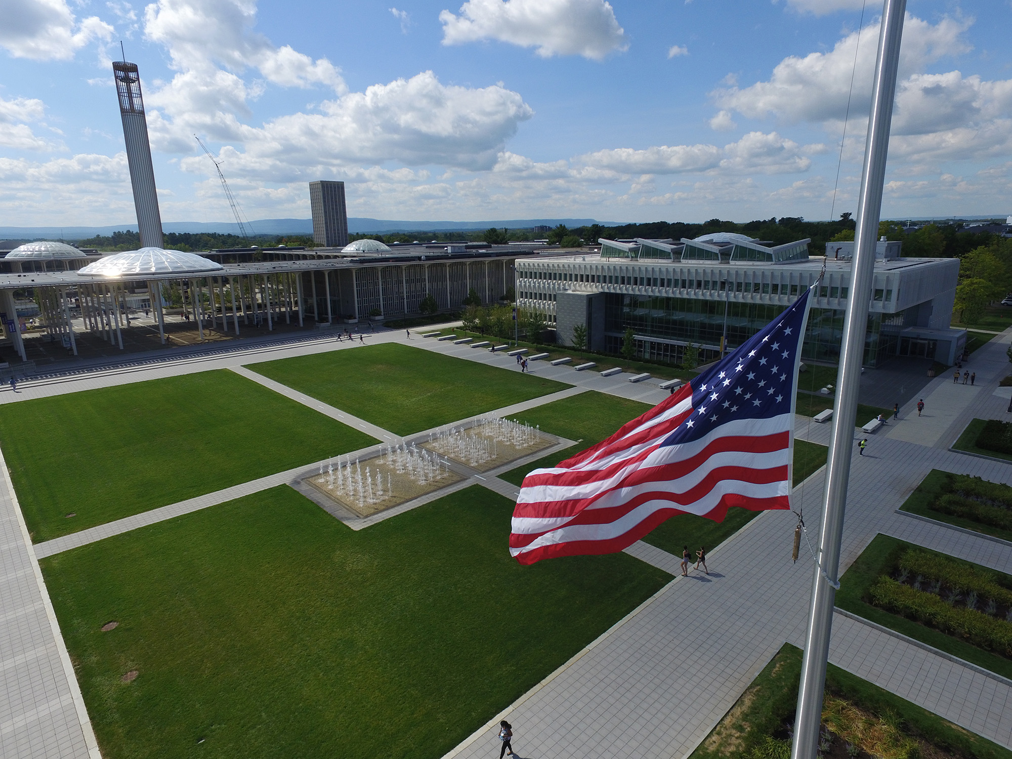 An American flag flies in front of UAlbany's Massry School of Business.